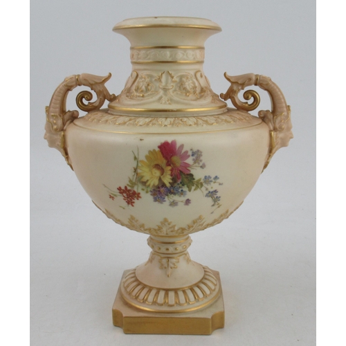 503 - A Royal Worcester blush ivory pedestal vase, decorated with field flowers, with scrolling mask handl... 