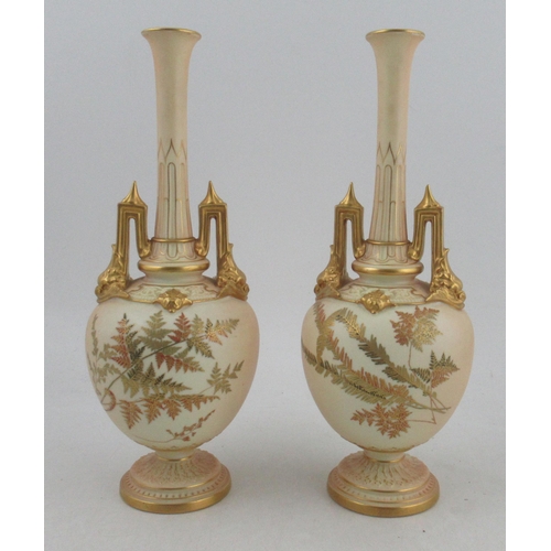 504 - A pair of Royal Worcester ivory vases, decorated with finely gilded ferns, minor chip to one handle ... 