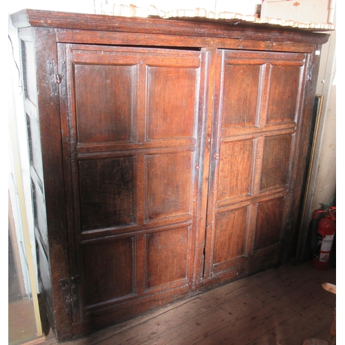 53 - An antique oak cupboard, the two doors, having six fielded panels to each door, width 67ins, height ... 