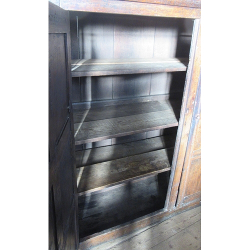 53 - An antique oak cupboard, the two doors, having six fielded panels to each door, width 67ins, height ... 