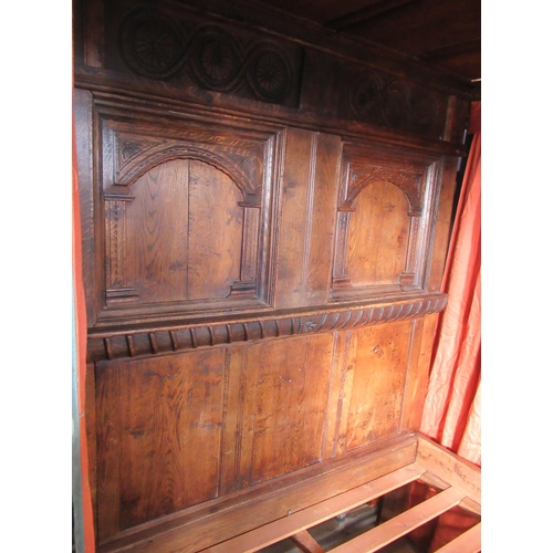 54 - An antique oak four post bed