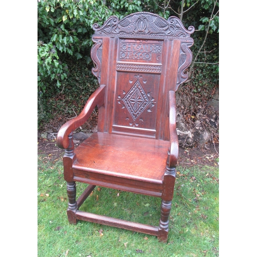 55 - An antique Oak Wainscot chair, the head rest having carved decoration and stamped Iohn Sandrs 1660