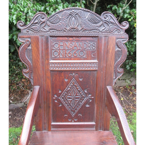 55 - An antique Oak Wainscot chair, the head rest having carved decoration and stamped Iohn Sandrs 1660