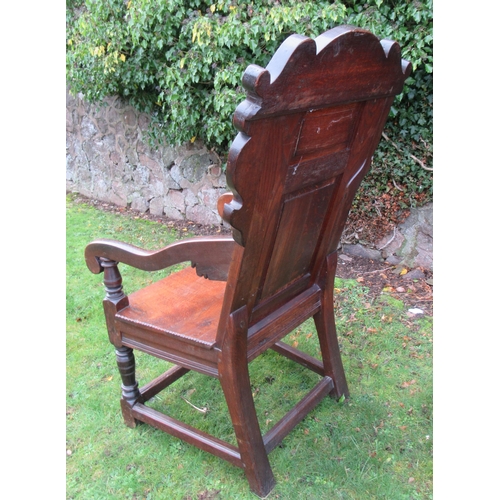 55 - An antique Oak Wainscot chair, the head rest having carved decoration and stamped Iohn Sandrs 1660