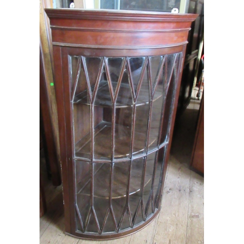 56 - A mahogany glazed barrel front corner cupboard