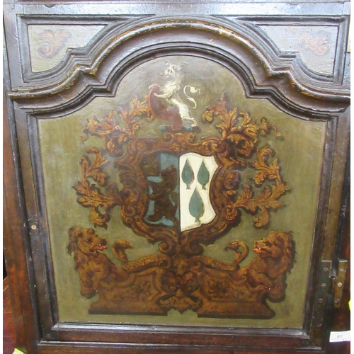 61 - An antique oak corner cupboard, decorated with a coat of arms, width 28ins, height 34ins