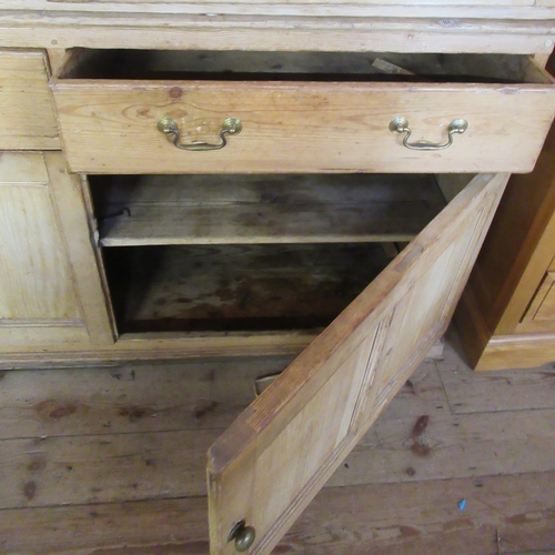 65 - A large pine kitchen cupboard, the upper section fitted with doors, opening to reveal shelves, with ... 