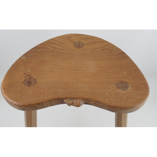 68 - A Robert Thompson Mouseman three legged stool, with kidney shaped top, raised on three octagonal leg... 