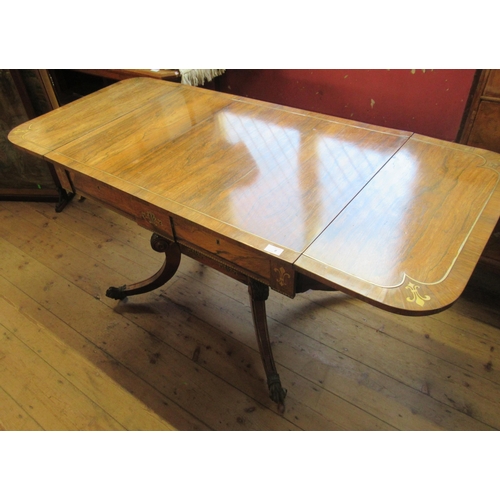 8 - A Regency rosewood sofa table, with brass stringing, fitted with two frieze drawers, with central br... 