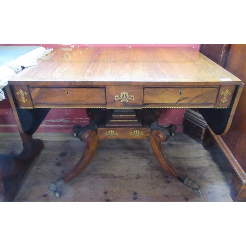 8 - A Regency rosewood sofa table, with brass stringing, fitted with two frieze drawers, with central br... 