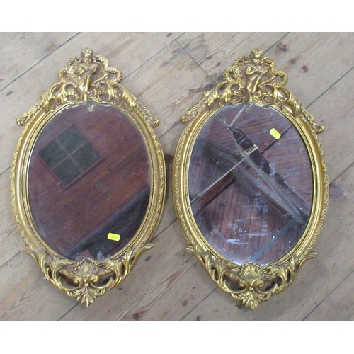 101 - A pair of oval wall mirrors, overall 21ins x 13.5ins