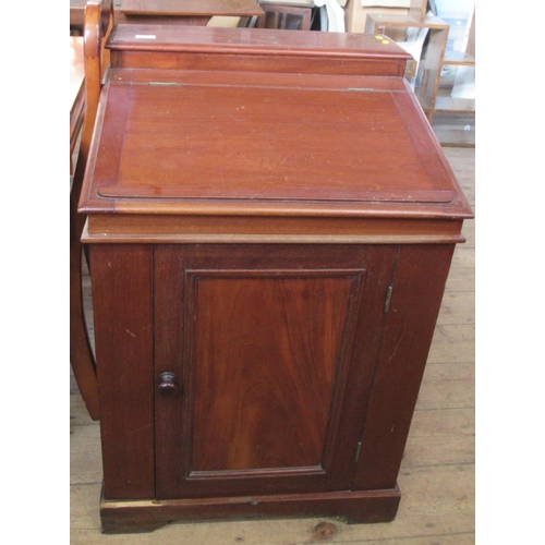 12 - A Victorian mahogany wash stand/desk, with sloping hinged lid, fitted with a cupboard