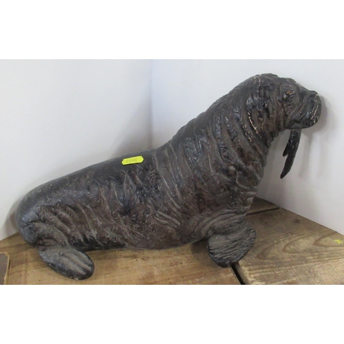 147 - A pottery model, of a walrus, height 9.5ins, length 14ins, together with two metal models