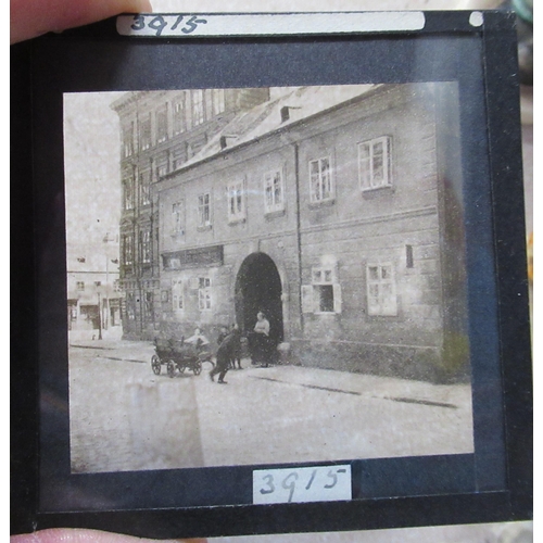 177 - Four pine boxes, containing glass slides with black and white images, to include portraits, building... 