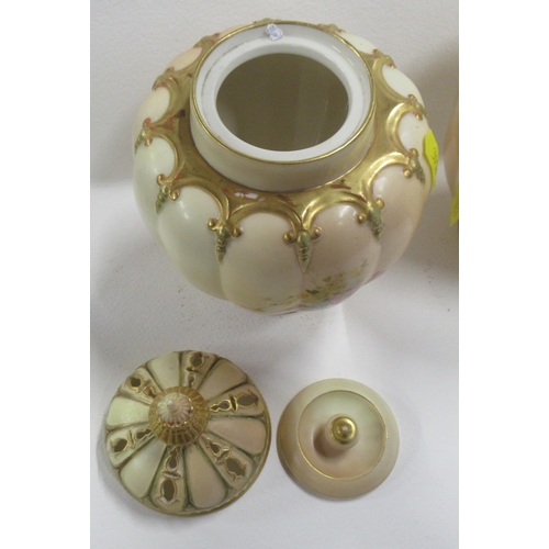 267 - Two Royal Worcester blush ivory vases, one with restored cover, decorated with floral sprays, shape ... 