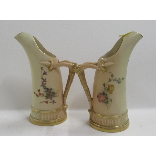 269 - A pair of Royal Worcester blush ivory tusk jugs, decorated with floral sprays, shape number 1116, he... 