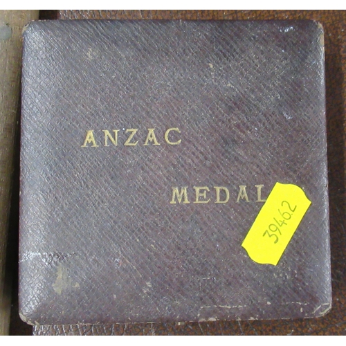 302 - A cased Anzac medal, together with a wooden cased knife