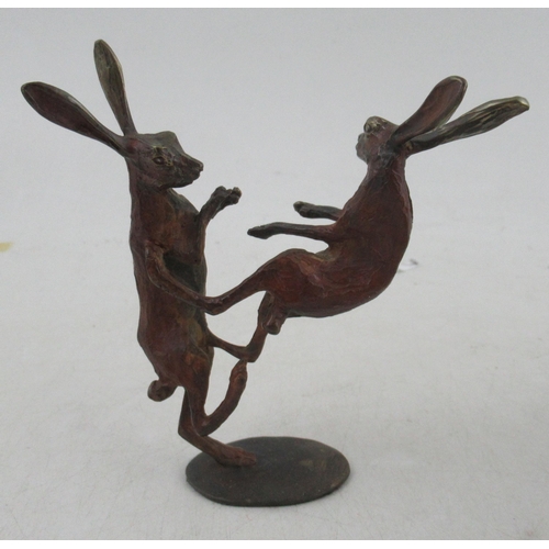 313 - Michael Storey, two painted bronze models, of a seated fox, height 5.25ins and two hares, height 4in... 