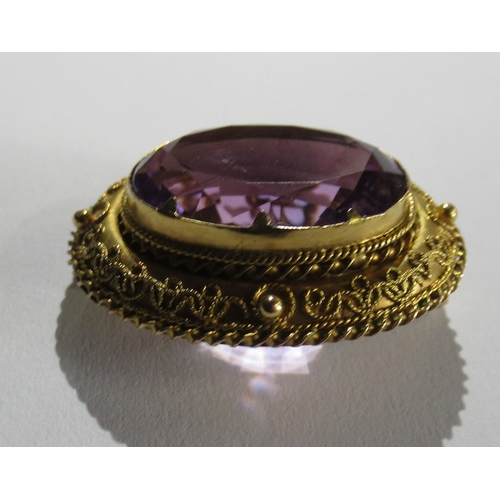 349 - A Victorian/Edwardian yellow gold brooch, with wirework detail, set single oval-cut amethyst