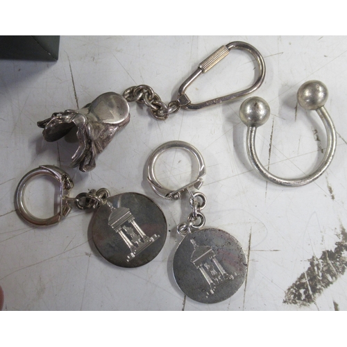 355 - Two silver Tattersalls keyrings, a silver saddle keyring, a gilt Ascot 1989 medal and two bottle sto... 