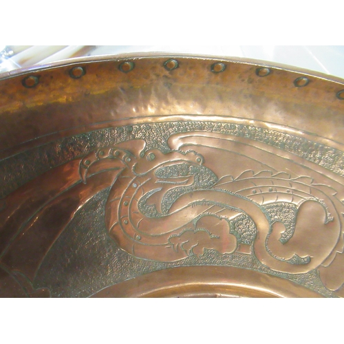 370 - A copper circular tray, decorated with dragons, together with a pair of trays