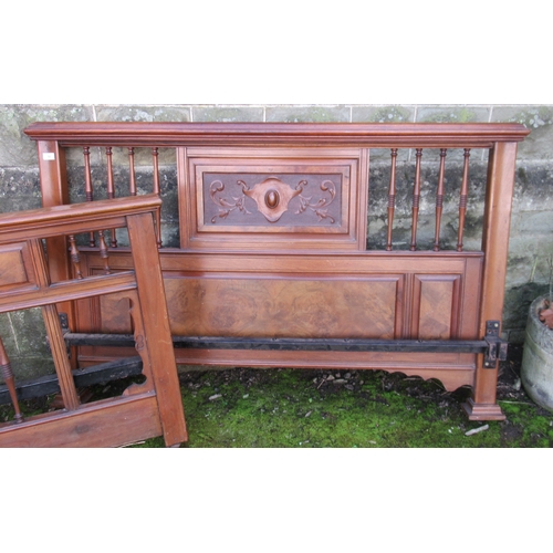 50 - A continental style walnut  bed frame, with carved decoration