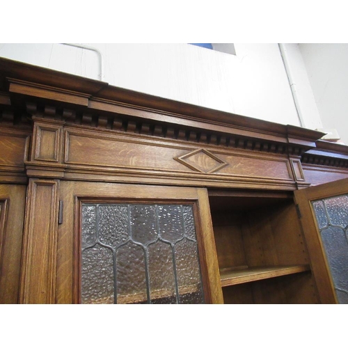 112 - A large 19th century oak cabinet the upper section having glazed lead doors opening to reveal shelve... 