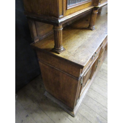 112 - A large 19th century oak cabinet the upper section having glazed lead doors opening to reveal shelve... 