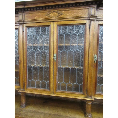 112 - A large 19th century oak cabinet the upper section having glazed lead doors opening to reveal shelve... 