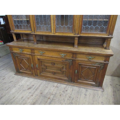 112 - A large 19th century oak cabinet the upper section having glazed lead doors opening to reveal shelve... 