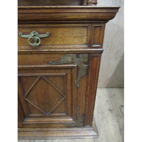 112 - A large 19th century oak cabinet the upper section having glazed lead doors opening to reveal shelve... 