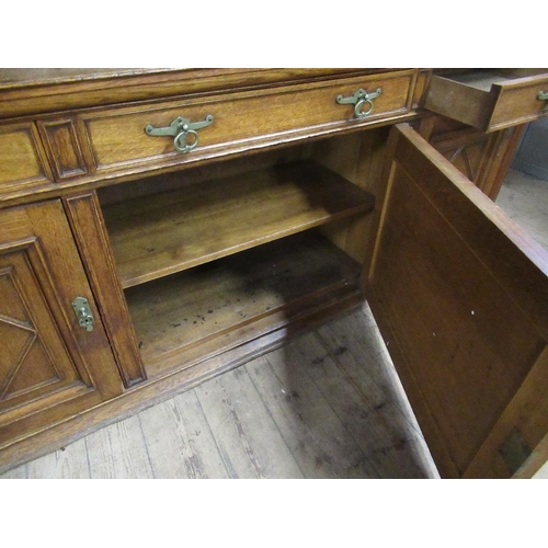 112 - A large 19th century oak cabinet the upper section having glazed lead doors opening to reveal shelve... 