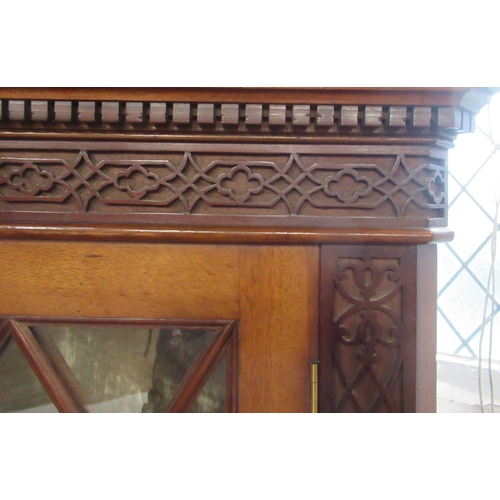 115 - A 19th century mahogany floor standing corner cupboard, with astragal glazed door and velvet lined i... 