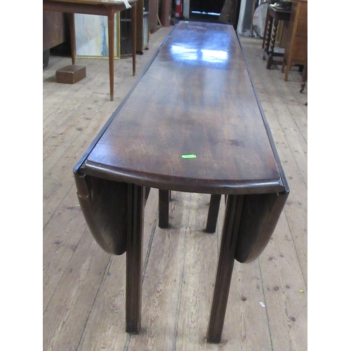 117 - A 19th century mahogany wake table, with double swing leg action and reeded legs, 88ins x 53.5ins, h... 