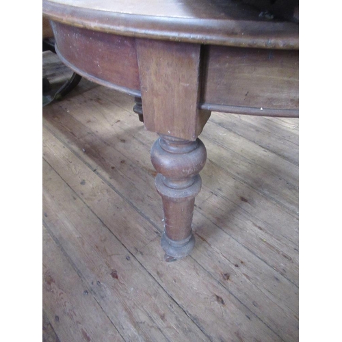 12 - A 19th century mahogany extending dining table with two leaves