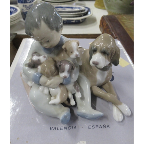 208 - Two Lladro models with boxes boy with dog an puppies and model of Polar bears