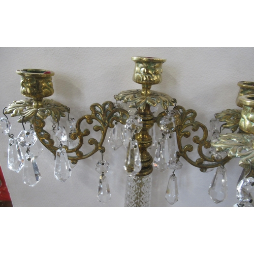 278 - A pair of brass and glass candelabra, with hanging glass lusters