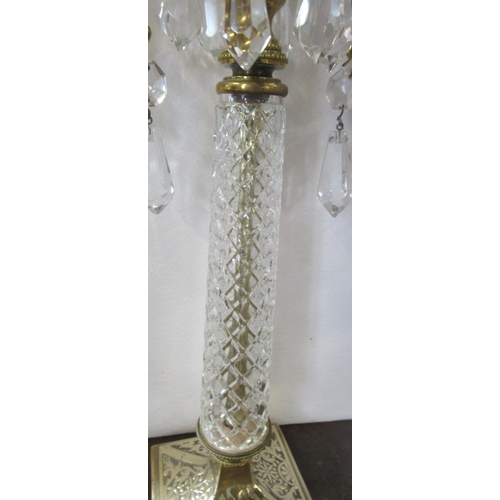 278 - A pair of brass and glass candelabra, with hanging glass lusters