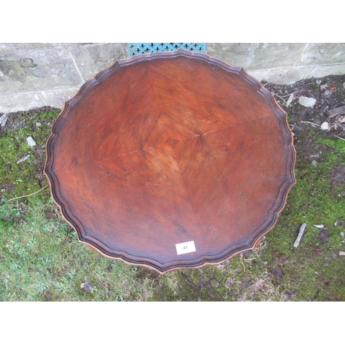 41 - A pie cut top walnut coffee table diameter 24ins, height 19ins