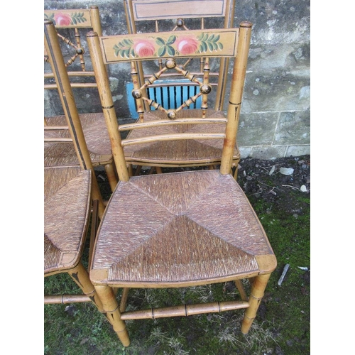 45 - A set of six rush seated chairs 3 of which have floral painted decoration