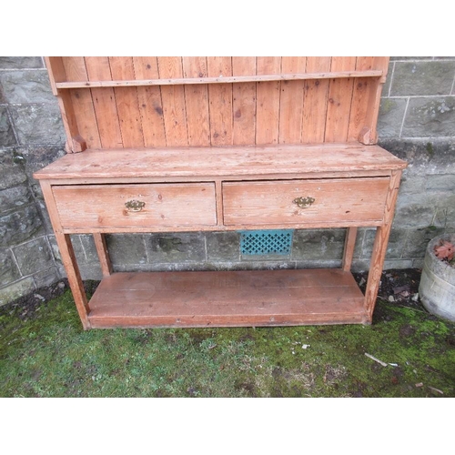 51 - An Antique pine dresser, with close boarded rack back, the base fitted with drawers and a shelf, wid... 