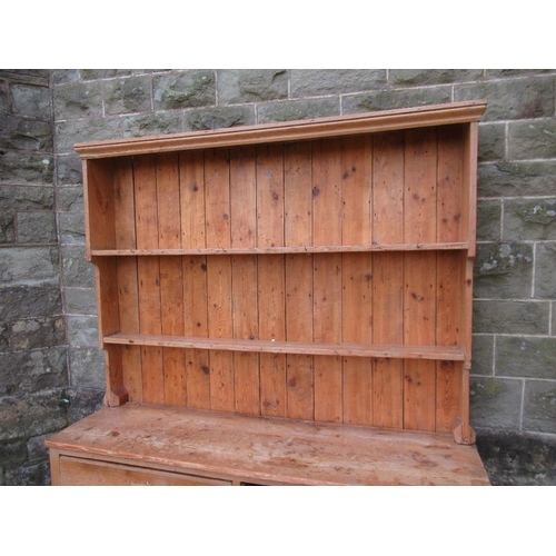 51 - An Antique pine dresser, with close boarded rack back, the base fitted with drawers and a shelf, wid... 