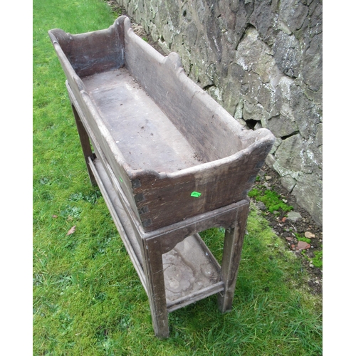 53 - An antique oak planter raised on a stand in distressed condition