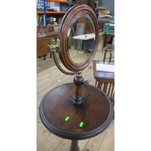 76 - A 19th century mahogany and brass shaving stand, with double sided swivel mirror , one side having a... 