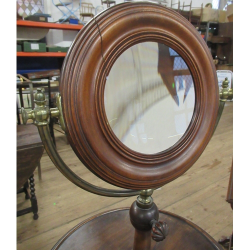 76 - A 19th century mahogany and brass shaving stand, with double sided swivel mirror , one side having a... 