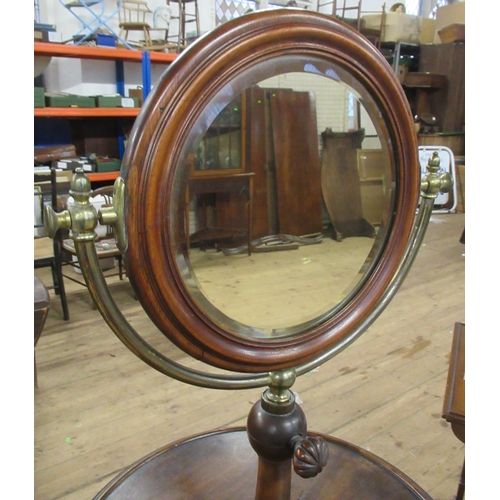 76 - A 19th century mahogany and brass shaving stand, with double sided swivel mirror , one side having a... 