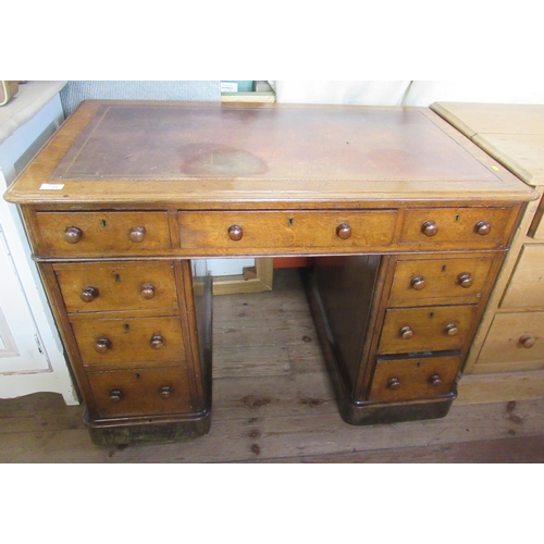 11 - A 19th century oak pedestal desk, with inset leather writing surface and an arrangement of nine draw... 