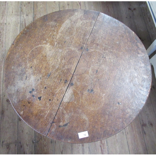 12 - An Antique oak tilt top table, with circular top, diameter 27.5ins, height 26ins