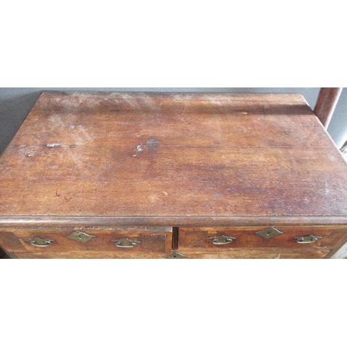 19 - An Antique oak and walnut chest, of two short over three long graduated drawers, on bun feet, 38ins ... 