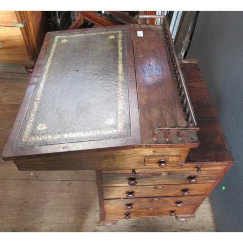 26 - A 19th century rosewood davenport, with inset leather sloping writing surface, the interior fitted w... 